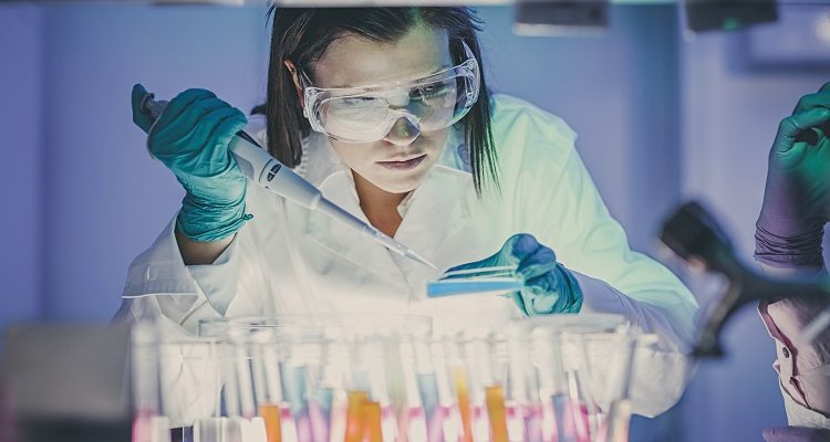 scientist, doctor, asistent working at the laboratory using pipette