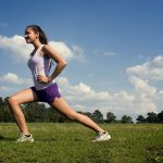 15250-a-young-woman-stretching-outdoors-before-exercising-pv